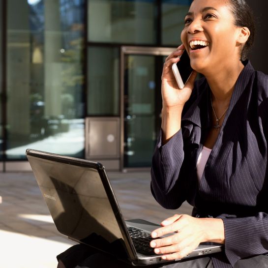 business woman smiling while on a phone call