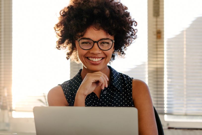 Woman smiling while taking an online business course